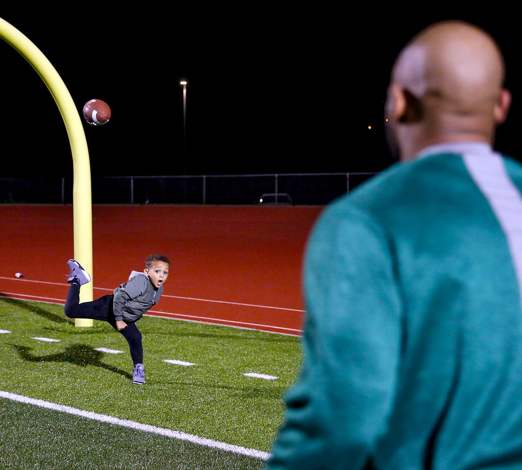Kaison Walker, 4, plays catch with his dad